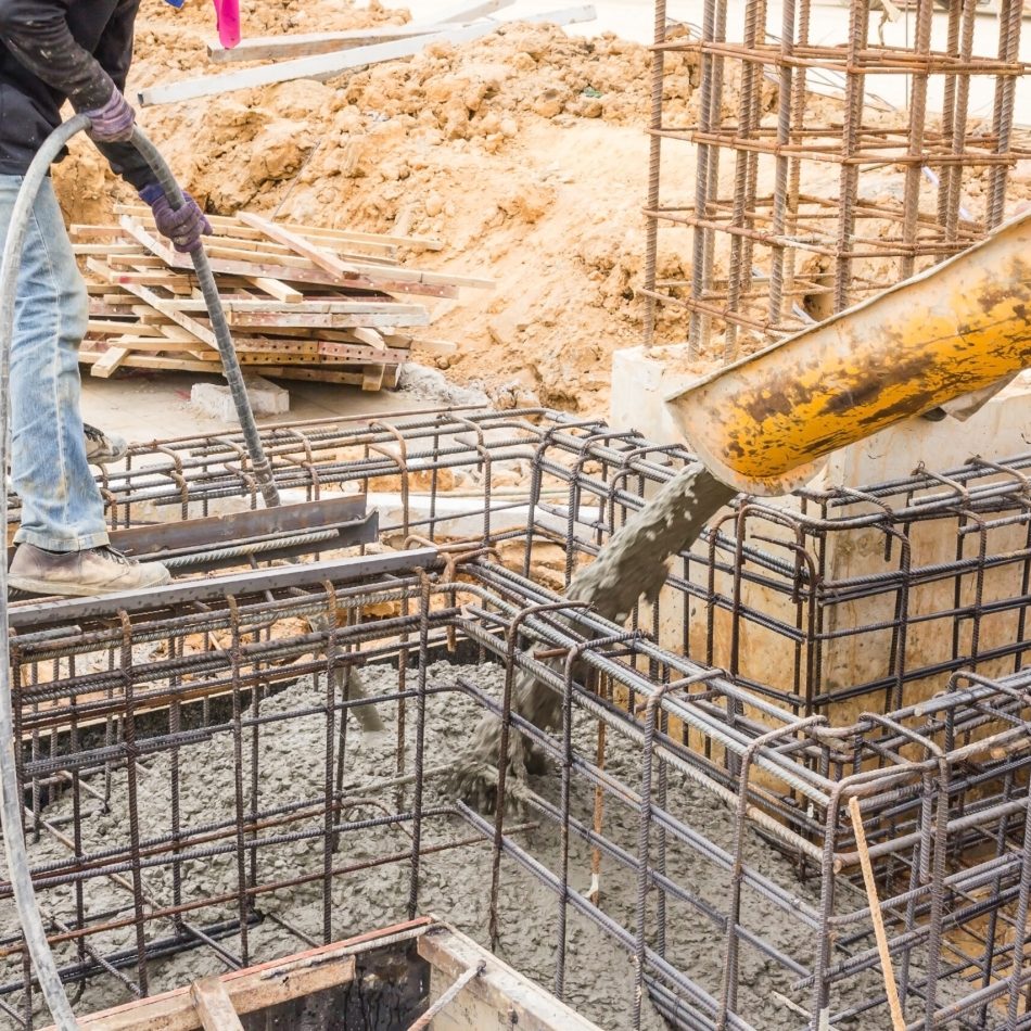 Concrete pouring during commercial concreting floors of buildings in construction site.